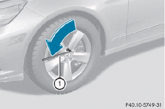 ► Using lug wrench 1, loosen the bolts on