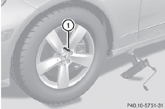 ► Unscrew the uppermost wheel bolt